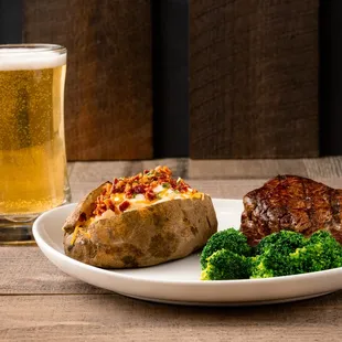 a plate of food and a glass of beer