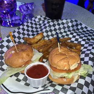 a sandwich and fries on a checkered plate