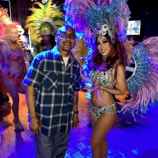 a man standing next to a woman in a costume
