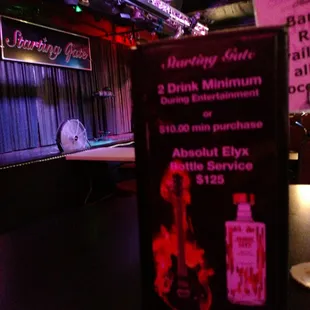a stage with a guitar and a bottle of liquor