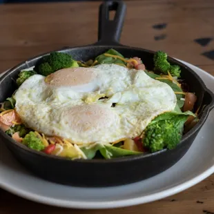a skillet with eggs and broccoli