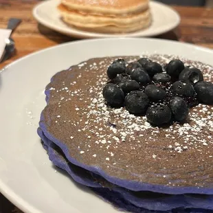 a stack of pancakes with blueberries on top
