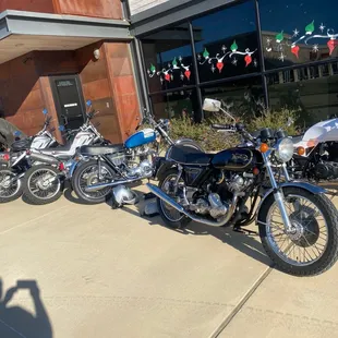 a row of motorcycles parked in front of a building