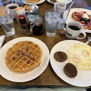 Pecan waffle, over easy eggs and sausage.