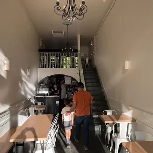 two people walking down a hallway