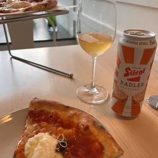 a slice of pizza and a glass of beer