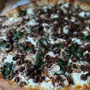 This pizza had spinach, olives and ricotta cheese. I added mushrooms.