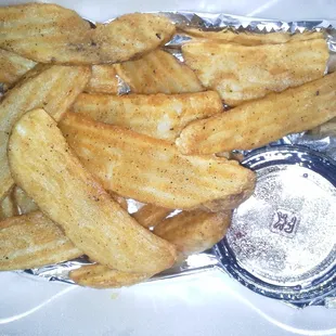 Jojo fries with side of ketchup.