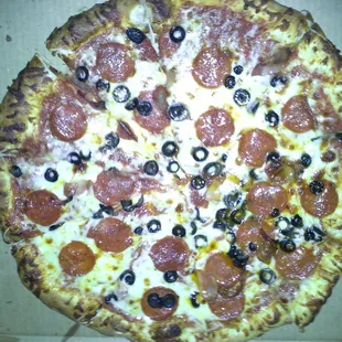 Extra large pepperoni,  bacon, and black olives pizza.