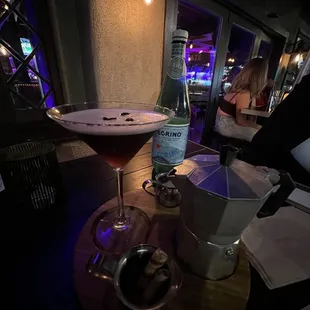 a cocktail and a beverage on a table