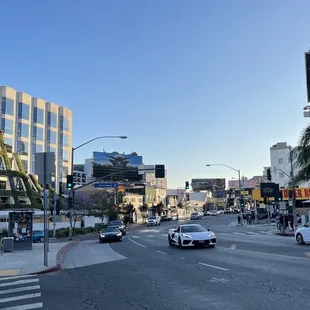 a city street with cars driving down it