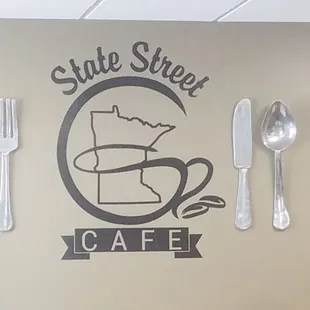 fork, spoon, and spoon rest on the wall