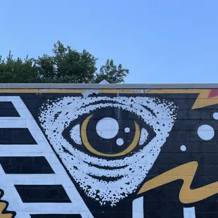 a painted mural of a pizza slice