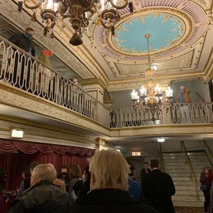 a crowd of people standing in a hall