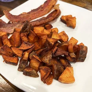 bacon and sweet potatoes on a white plate