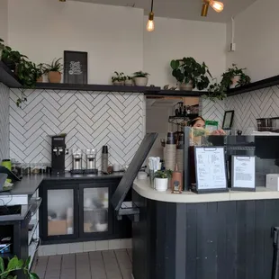 a kitchen with black cabinets and white tiles
