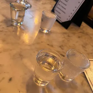 three shot glasses on a marble table