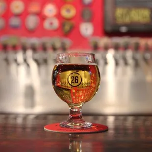 a glass of beer on a bar