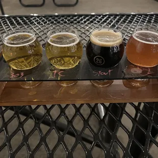 a flight of beers on a tray