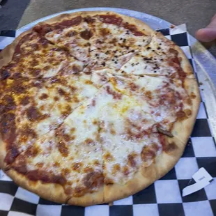 a pizza on a checkered plate