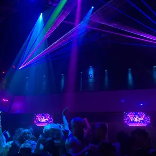 a crowd of people dancing at a nightclub