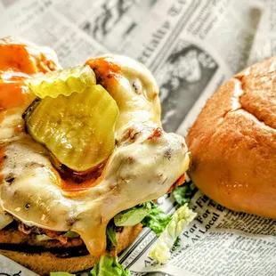 The Buffalo Sandwich: Grilled or fried chicken tossed in house made Buffalo, topped with shredded lettuce and smoked Gouda, on Brioche bun.