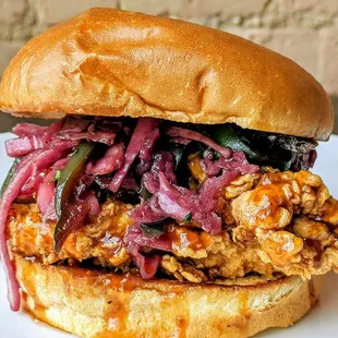Korean Chicken Sandwich: Grilled or fried chicken, Korean BBQ sauce, topped with Korean slaw, between brioche bun.