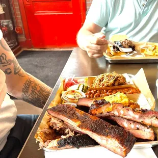 Ribs, pulled pork, baked beans, cornbread casserole, pickled onions, and more!