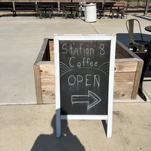 a chalkboard sign for the station 8 coffee lounge