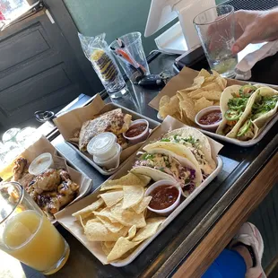 Chicken and bulgogi tacos in front, quesadilla back right and grilled wings back left. All phenomenal