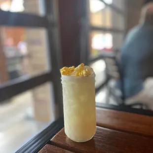 a glass of lemonade on a table