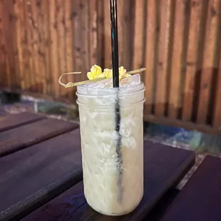 a drink in a jar with a straw