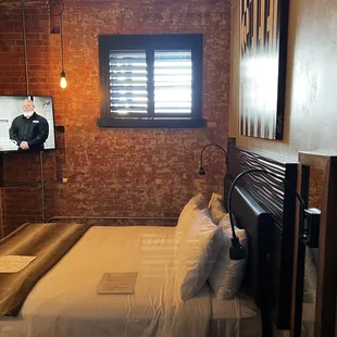 a bedroom with brick walls