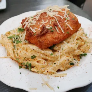 Cajun Alfredo Pasta topped with Deep Fried Salmon