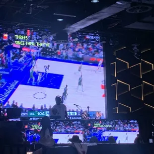a basketball game on a big screen