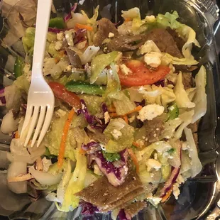 About half of the large salad with gyro meat and feta