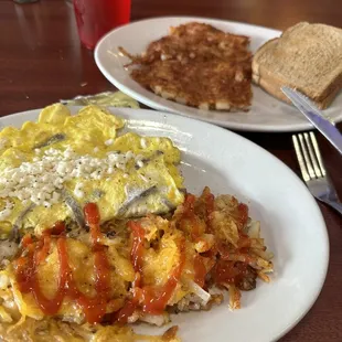 Gyro omelette with crispy hash rows (add cheddar), corned beef hash, and wheat toast. Yum!