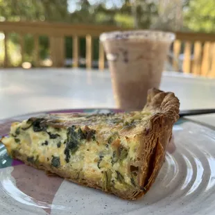 a slice of quiche on a plate