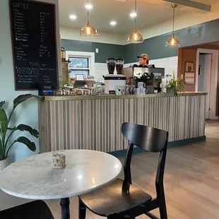 Counter where you order and a menu listing on the wall