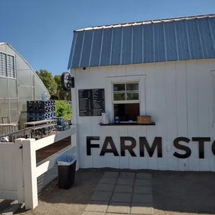 a white building with a sign that says farm store