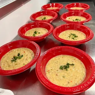 a row of red bowls of soup
