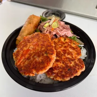 2 pc. Salmon cake bowl, comes with a piece of chicken eggroll, steamed rice and papaya slaw.