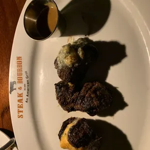 a plate of steak and a cup of coffee