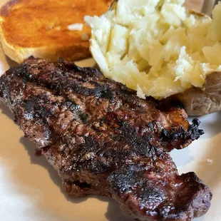 New York strip w/ baked potato and cheese bread.
