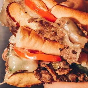 a hand holding a sandwich