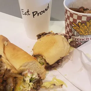 Three cheesesteak sandwich with fries and to drink some Sprite.