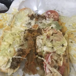 two subs with cheese and lettuce