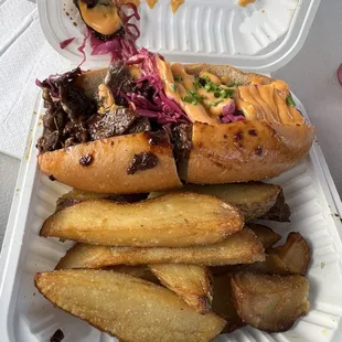 Bulgogi cheesesteak sandwich with steak fries.