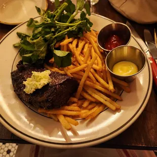 The highlight of the meal-the hanger steak with shoestring fries and greens
