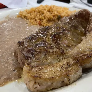 Ribeye 12 oz rice and beans with a slice of white bread